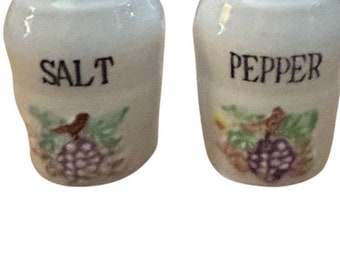 Vintage white salt and pepper shakers with purple grapes