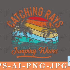 May include: A vintage-style graphic design with the text "Catching Rays Jumping Waves". The design features a sunset with palm trees and a surfer riding a wave.
