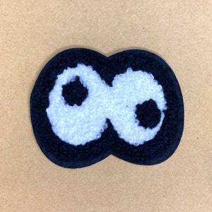May include: Black and white felt patch shaped like the infinity symbol. The symbol is outlined in black and filled in with white.