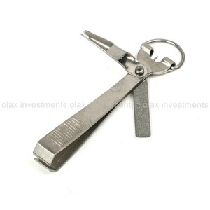 May include: A silver fishing line tool with a line cutter, a hook remover, and a line sharpener. The tool has a ring on the top for attaching to a keychain.