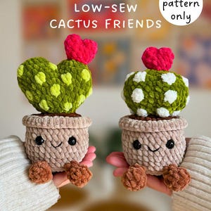 May include: Two crocheted cactus figures, one heart-shaped and one round, each with a red heart on top. They sit in tan pots with smiling faces and brown pom-pom feet. The text "LOW-SEW CACTUS FRIENDS" and "PDF pattern only" are visible.
