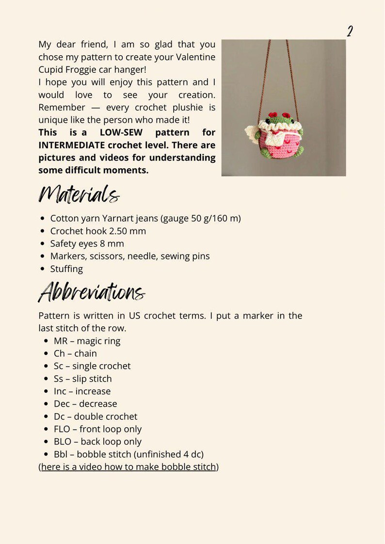 May include: Crochet pattern for an amigurumi frog wearing a pink dress and holding a white crocheted heart. The pattern is for an intermediate crochet level and includes pictures and videos for understanding difficult moments. The pattern is written in US crochet terms.