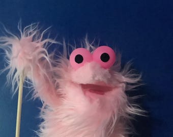 A pink hand and rod puppet