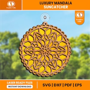 May include: A laser-cut wooden mandala suncatcher with a yellow and brown color scheme. The suncatcher is round and has a intricate design. It is hanging from a suction cup.