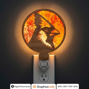 May include: Wooden night light featuring a cardinal bird design. The bird is silhouetted against a warm, orange-toned background within a circular frame. The night light plugs into a standard wall outlet.