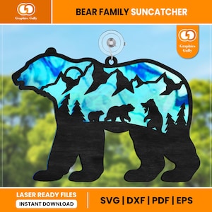 May include: A black silhouette of a bear family with a mountain and forest scene inside. The bear family is standing on a mountain with trees and a moon in the background. The bear family is a mother bear, a father bear, and a baby bear. The image is a laser cut design for a suncatcher.