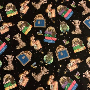 May include: Black fabric with a repeating pattern of whimsical cats. The cats are depicted in various poses, some wearing crowns and resting on colorful pillows. Other elements include clocks, mirrors, and fishbowls, all set against a backdrop of tiny pink dots.