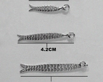 May include: Three silver fish charms of varying sizes, measuring 3 cm, 4.2 cm, and 5.3 cm. The charms are detailed with scales and have a loop for attaching to a necklace or bracelet.