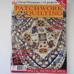 May include: The cover of "Australia Patchwork & Quilting" magazine features a colorful quilt with star and geometric patterns. The magazine has a yellow and red banner with the title and the words "Special Showcase Issue".