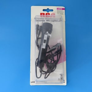 May include: A black RCA replacement cassette microphone in original blister packaging. The microphone features an on-off switch and a black cord with two plugs. The packaging includes the text RCA, Popular Replacement Cassette Microphone, and Audio.
