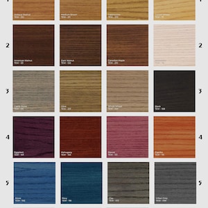 May include: A chart of 24 wood stain colors with their names and corresponding codes. The colors are arranged in rows and columns, with each color having a different shade of brown, red, blue, green, or gray.