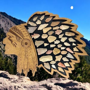 May include: Wooden Native American headdress shaped display with a profile of a Native American man with a feather headdress. The headdress is filled with various arrowheads.