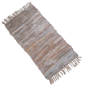 May include: A woven rug with a fringe on both ends. The rug is made of natural fibres and has a light brown, beige, and grey colour scheme.