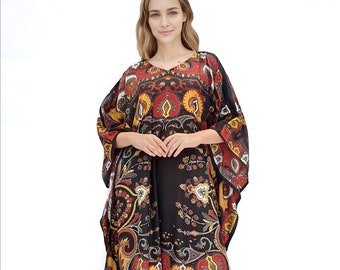 May include: A black maxi dress with a colourful paisley print. The dress has a V-neckline and long sleeves. The model is wearing black sandals.