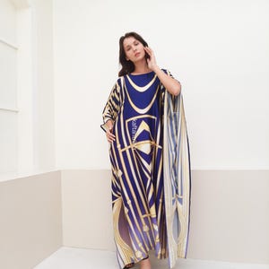 May include: A long, flowing kaftan with a geometric pattern in shades of blue, gold, and white. The kaftan has a loose, comfortable fit and is perfect for warm weather.