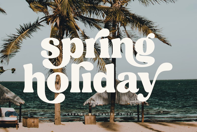 May include: White text on a beach background with palm trees. The text reads "spring holiday" with a stylized font. The text is created by Shakira Studio.