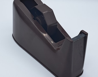 May include: A brown plastic tape dispenser with a clear tape slot and a black tape cutter.