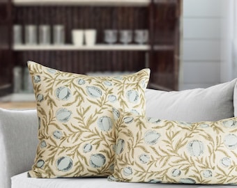 May include: Two throw pillows with a cream-colored background featuring a repeating pattern of light blue pomegranate-like fruits and olive green leafy branches. The set includes one square pillow and one rectangular lumbar pillow.