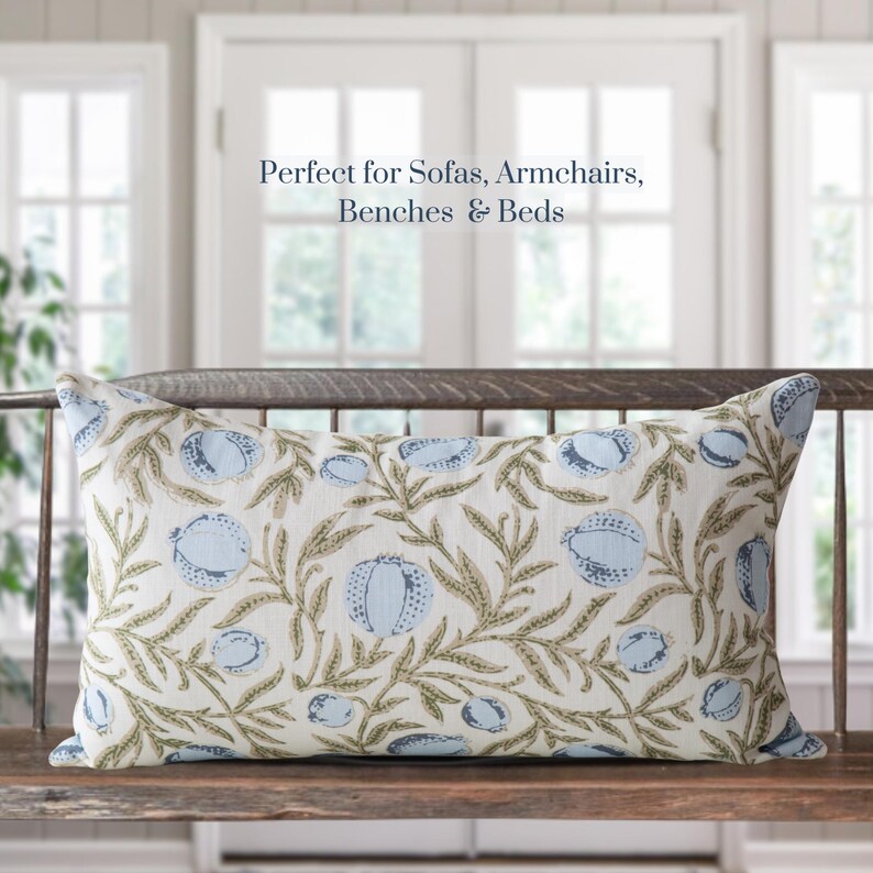 May include: Rectangular decorative pillow with a botanical pattern. The pillow features a cream-colored background with a repeating design of blue fruit and green leaves. The text "Perfect for Sofas, Armchairs, Benches & Beds" is displayed above the pillow.