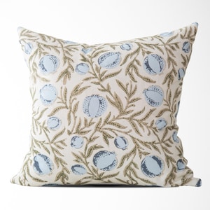 May include: Square decorative pillow with a repeating pattern of light blue fruit and olive-green leaves on a cream background. The pillow is a square shape and appears to be made of fabric. The design is a botanical theme.
