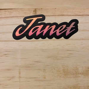 An example of the custom purple holographic name on wooden background.