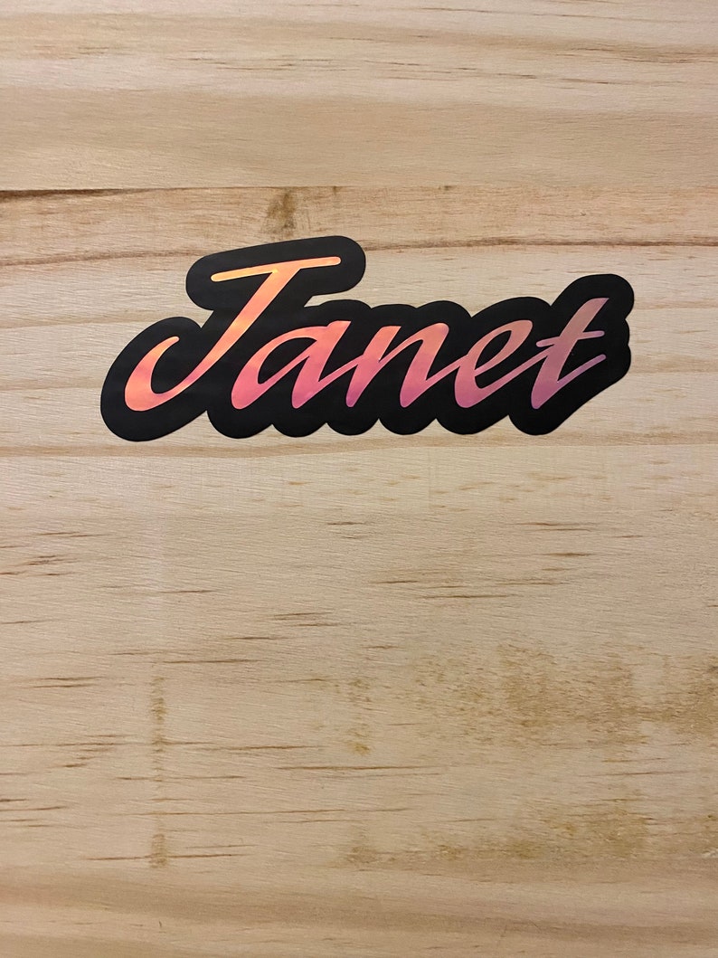 An example of the custom purple holographic name on wooden background.