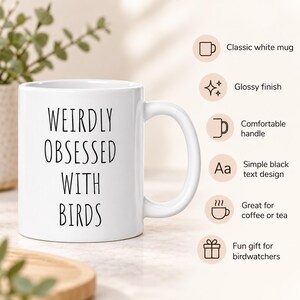 May include: A white ceramic mug with a glossy finish and a comfortable handle. The front features the black text WEIRDLY OBSESSED WITH BIRDS in a simple font. The mug is presented alongside icons and text describing it as a classic white mug.