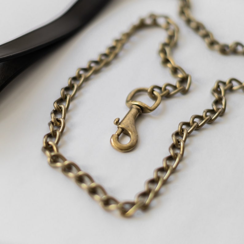 May include: A gold chain with a hook clasp. The chain is made of metal links and is about 18 inches long.