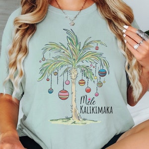 Colores cómodos Camisa de palmera navideña Camiseta Mele Kalikimaka Camiseta de árbol de Navidad tropical Camiseta navideña de playa Camisetas familiares de Navidad