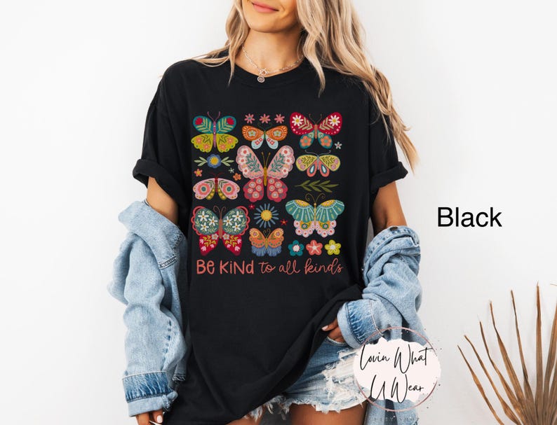 May include: Black t-shirt with a colorful butterfly design and the text "Be Kind to all kinds".
