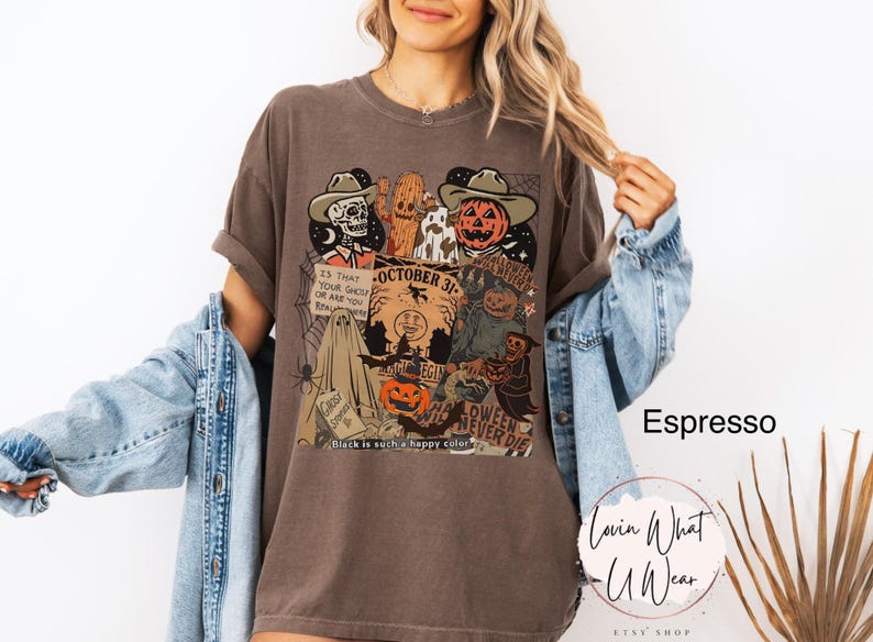 May include: Espresso-colored t-shirt with a Halloween-themed graphic. The design features a skeleton, a pumpkin, and other spooky characters. Text includes "October 31" and "Halloween Never Die". The shirt is part of a clothing collection.