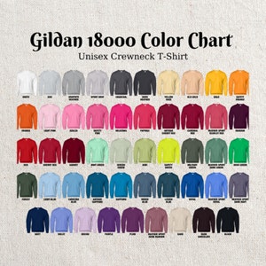 May include: Colour chart for Gildan 18000 unisex crewneck t-shirts. The chart shows 48 different colours, including white, ash, graphite, sport grey, charcoal, dark heather, yellow haze, old gold, gold, safety orange, orange, light pink, azalea, safety pink,  heliconia, paprika, antique cherry red, cardinal red, heather sport scarlet red, maroon, red, cherry red, garnet, mint green, serene green, kiwi, safety green, military green, heather sport dark green, irish green, forest, light blue, carolina blue, antique sapphire, sapphire, indigo blue, legion blue, royal, heather sport dark navy, navy, violet, orchid, purple, plum, heather sport dark maroon, sand, dark chocolate, and black.
