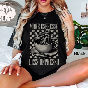 May include: Black t-shirt with a skeleton in a coffee cup graphic and the text "More Espresso Less Depresso".