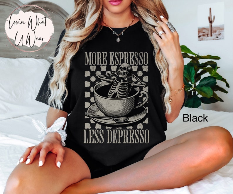 May include: Black t-shirt with a skeleton in a coffee cup graphic and the text "More Espresso Less Depresso".