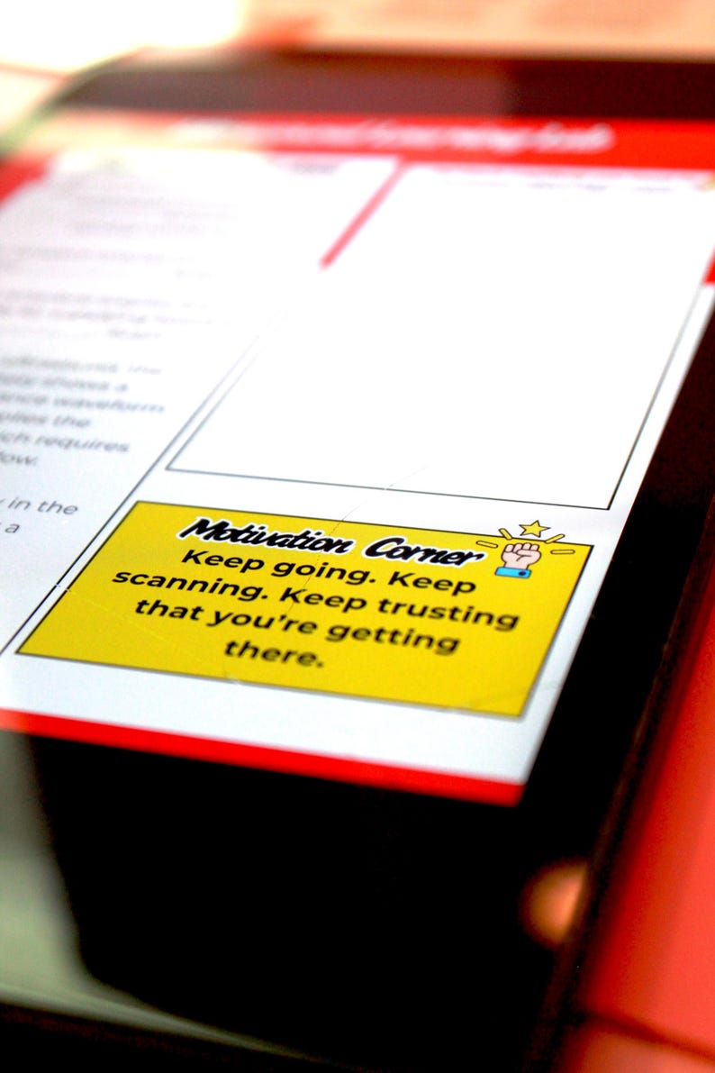 May include: A close-up of a document with a yellow sticky note in the corner. The note reads "Motivation Corner" and includes motivational text. The document has a red border and is on a black surface.