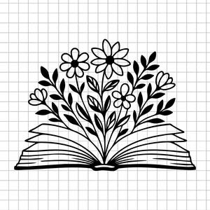 May include: Black and white line art illustration of an open book with flowers and leaves growing from the pages. The image is on a grid background, suggesting a design or craft project.
