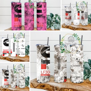 May include: Set of six stainless steel tumblers with various designs featuring the Cummins logo and Fleetguard text. The tumblers have a distressed white background with black, red, and pink accents.