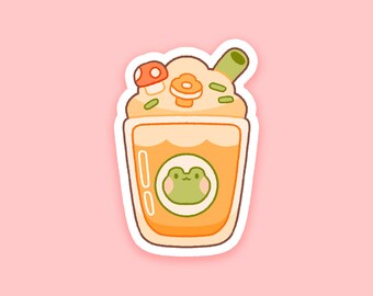 May include: A sticker featuring a cartoon beverage with a frog face, mushroom, and flower. The drink is in a clear cup with a light orange liquid. The frog is green, and the mushroom is red and white. The sticker has a white border and is on a pink background.
