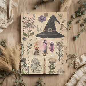 May include: A notebook with a vintage-style illustration featuring a witch's hat, crystals, candles, and botanical elements. The cover has a beige background with detailed drawings in shades of black, brown, and purple. The notebook is surrounded by dried plants and fabric.