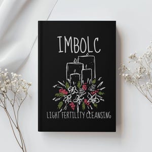 May include: A black journal with the word "IMBOLC" in white script above a drawing of three lit candles surrounded by flowers and the text "LIGHT FERTILITY CLEANSING".