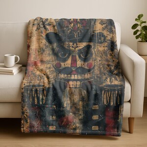 May include: A decorative throw blanket featuring a distressed design of a nutcracker soldier. The blanket has a vintage aesthetic with a color palette of brown, black, and red. Snowflake and geometric patterns are also visible.