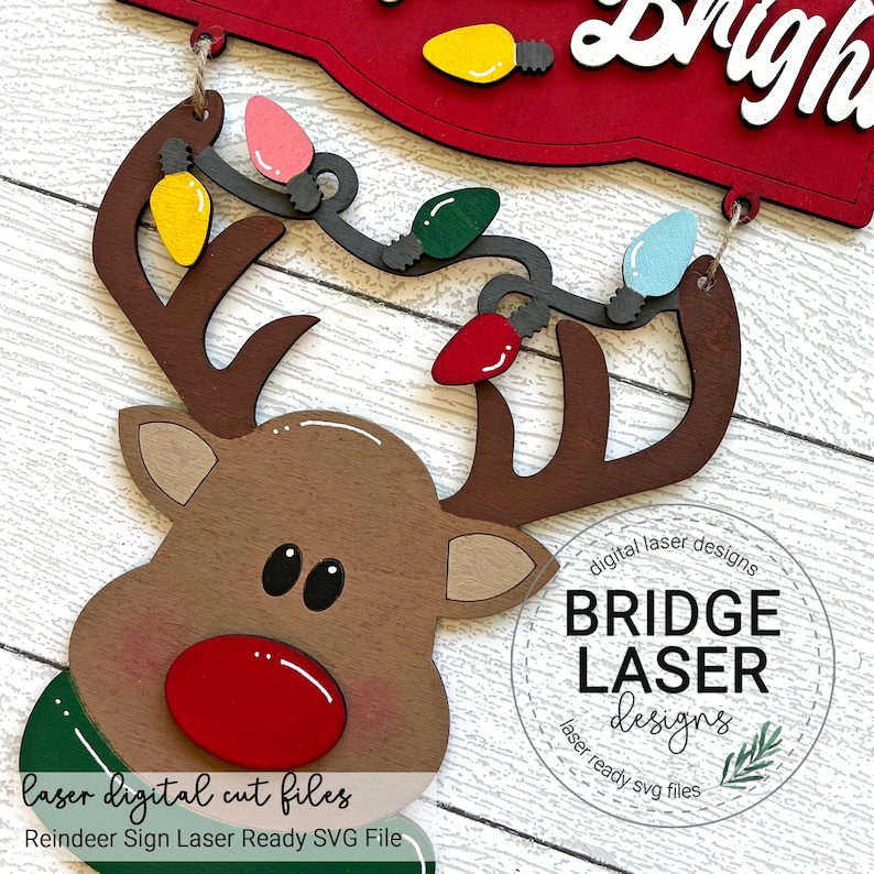 May include: A laser cut SVG file design for a reindeer sign with a string of lights. The sign says "It's the most wonderful time of the year". The design is for a laser cutter and is ready to be cut.