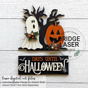 May include: A Halloween-themed wooden decoration featuring a ghost, jack-o'-lantern, and a sign that reads "DAYS UNTIL HALLOWEEN." The ghost and pumpkin are orange, black, and white. The sign is black with white and orange lettering. The decoration is designed for an advent shelf.