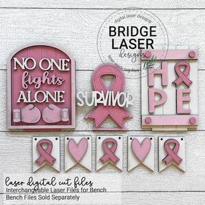 Peut inclure: Plusieurs &eacute;l&eacute;ments en bois d&eacute;coup&eacute;s au laser, roses et blancs, avec les mots &laquo;&nbsp;NO ONE fights ALONE&nbsp;&raquo;, &laquo;&nbsp;SURVIVOR&nbsp;&raquo; et &laquo;&nbsp;HOPE&nbsp;&raquo;. L'image comprend des rubans et des c&oelig;urs roses, et une banni&egrave;re avec &laquo;&nbsp;Laser Digital Cut Files&nbsp;&raquo;.