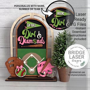 May include: A multi-layered wooden sign featuring a softball theme with the text Dirt & Diamonds, a baseball field graphic, a brown glove, a pink helmet, a bat, and a softball with a pink bow. Includes a circular inset showing personalization.