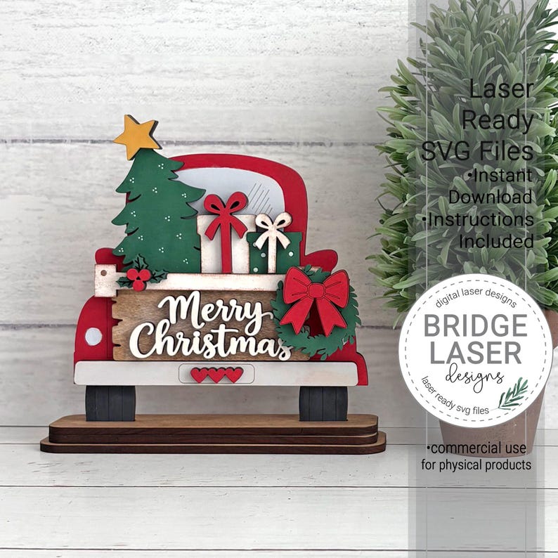 May include: A layered wooden cutout of a red truck bed carrying a green Christmas tree, two gift boxes with bows, and a wreath. The truck features a sign with the text Merry Christmas, three small red hearts, and a yellow star on the tree.