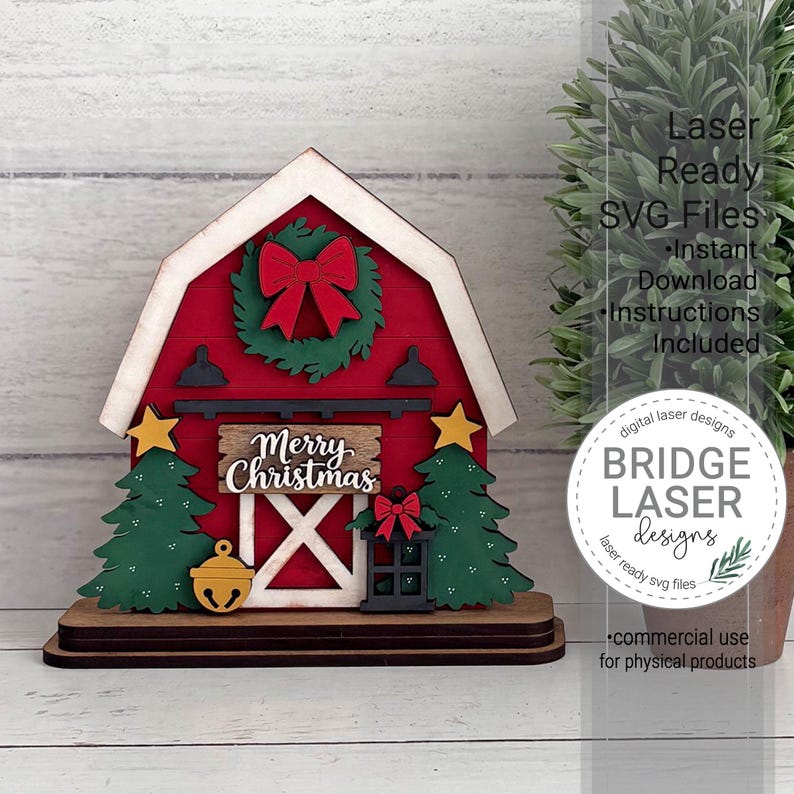 May include: A layered wooden barn-shaped Christmas decoration featuring a red facade, a green wreath with a red bow, two green pine trees, a yellow star, a yellow bell, a black lantern, and a sign with the text Merry Christmas.
