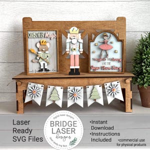 May include: Wooden Christmas display with a mouse, a nutcracker, and a ballerina. A banner with snowflake and tree cutouts is included. The text on the display reads "Christmas Magic" and "Be magical and cheery like the Sugar Plum Fairy."