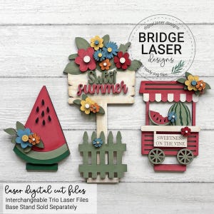 May include: Wooden summer decorations featuring a watermelon slice, a sign reading "Sweet Summer", and a watermelon stand. The decorations are embellished with colourful paper flowers and the text "Sweetness on the Vine".