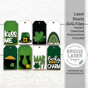 May include: Eight laser-cut wood tags with a St. Patrick's Day theme. The tags feature various designs including a pot of gold, a horseshoe, a leprechaun hat, a shamrock, a rainbow, and the words "Kiss Me", "Mar 17", and "Lucky Charm".